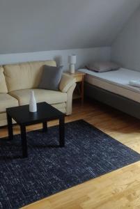 a living room with a couch and a coffee table at Åberg12 in Höör