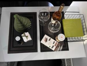 a white table topped with a white table with wine glasses at Only2Suites in Athens
