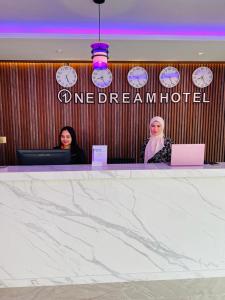 dwie kobiety siedzące przy ladzie w hotelu w obiekcie One Dream Hotel w mieście Petaling Jaya