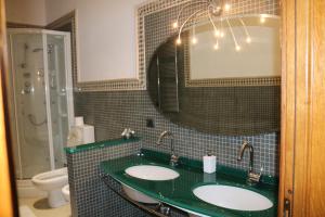 a bathroom with two sinks and a mirror at Sant'Anna in Saluzzo