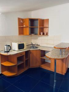 a kitchen with a sink and a microwave at Hostel Serge in Lviv