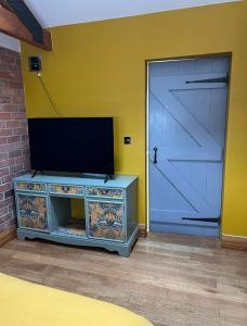 a garage door with a flat screen tv on top at Aplanty House: A Hidden Gem in The Heart of The Fens in Wisbech