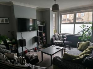 a living room with two couches and a table at Bromley in Bickley +5 photos
