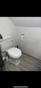 a bathroom with a white toilet in a room at I bedroom flat on a gated farm in Tadworth in Purley