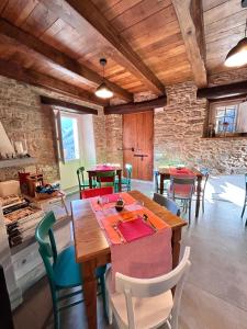 a dining room with tables and chairs in a building at B&B Convivium in Stazzema