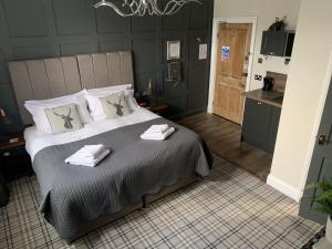 a bedroom with a large bed with towels on it at Castle View Bed and Breakfast in Morpeth