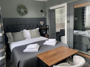 a bedroom with a bed with towels on it at Castle View Bed and Breakfast in Morpeth
