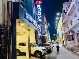 a man walking down a street in front of a store at Stay Court - Business Class Hotel - Near Central Railway Station in Chennai