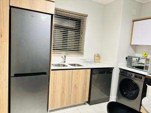 a kitchen with a refrigerator and a sink at Coastal Retreats in Ballito