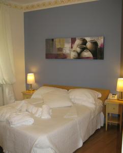 a bedroom with a bed with towels on it at Hotel Argentina in Santa Margherita Ligure