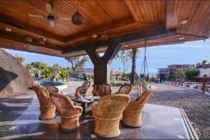 a group of wicker chairs sitting on a patio at Abbey Cottage in Dharamshala