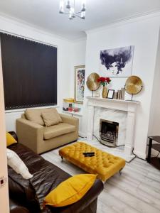 a living room with a couch and a fireplace at Gorgeous Stylish Cheri Victorian House In Manchester in Manchester