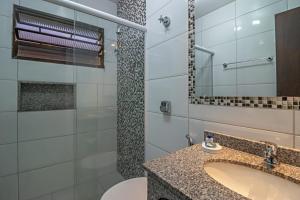 a bathroom with a sink and a mirror at Pousada do Lago in Brotas