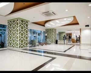 a lobby with people walking in a building at APARTMENT GRAND KAMALA LAGOON MY KIDS in Pulosirih