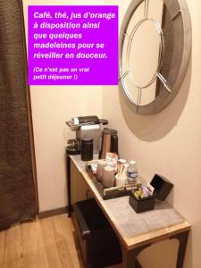a bathroom with a table with a mirror on the wall at SECRET33 in Floirac