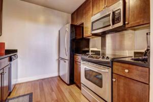 a kitchen with stainless steel appliances and wooden cabinets at Chase Penthouse at 39 west Baltimore Inner Harbor Convention center free indoor parking one and two bedrooms in Baltimore