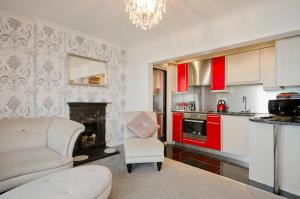 a living room with a couch and a fireplace at Seaview Regency Apartment With Private Parking in Brighton & Hove