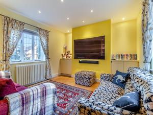 a living room with two couches and a flat screen tv at The Farmhouse - Uk45894 in Banham