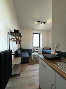 a room with a kitchen and a living room at Cunabu Apartments in Rome