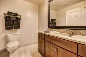 a bathroom with a toilet and a sink and a mirror at Chase Penthouse at 39 west Baltimore Inner Harbor Convention center free indoor parking one and two bedrooms in Baltimore