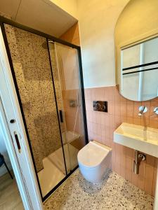 a bathroom with a shower and a toilet and a sink at Cunabu Apartments in Rome