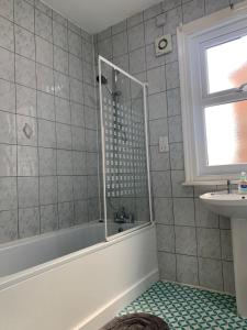 a bathroom with a shower and a sink at Burton Villa Guest House in York