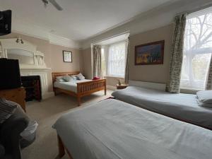 a hotel room with two beds and a fireplace at Burton Villa Guest House in York