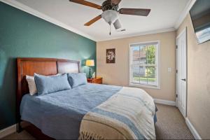a bedroom with a bed and a ceiling fan at Creekside Cottage*Hot Tub*Entire Home-Pigeon Forge in Pigeon Forge
