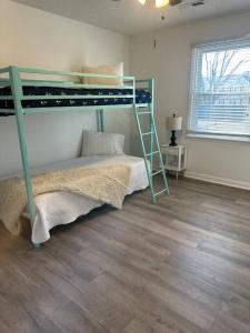 a bedroom with a bunk bed and a ladder at Just like home! in Huntsville