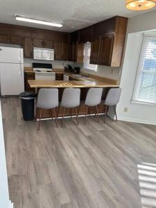 a kitchen with a table and chairs and a refrigerator at Just like home! in Huntsville