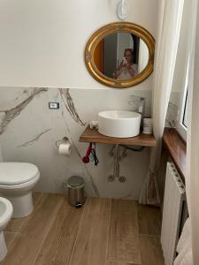 a person taking a picture of a bathroom with a mirror at Villa Mirella in Numana