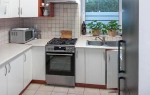 a kitchen with a stove and a microwave at Awesome Home In Pisz With Wi-fi in Pisz