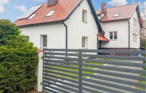a house with a fence in front of it at Awesome Home In Pisz With Wi-fi in Pisz