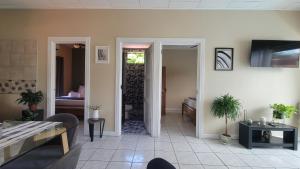 a living room with a door open to a dining room at Henko House in Quepos