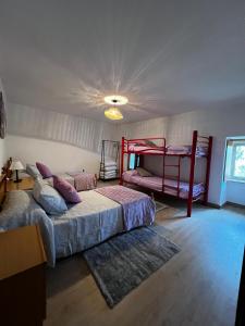 a bedroom with two bunk beds and a rug at Sola Costeiro in Padrenda +13 photos