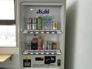 a refrigerator filled with lots of bottles of soda at CHENDA INTERNATIONAL HOTEL - Vacation STAY 99536v in Seki