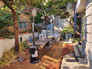 a patio with a table and a street light at Sg Tailored Serviced Home 5min Walk From Metro in Seoul