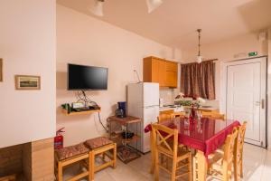 a kitchen with a table and a refrigerator at Cretan View in Stavros