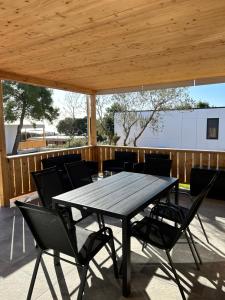 a wooden table and chairs on a patio at Holiday Homes Ahil 7&8 in Pakoštane