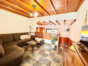 a living room with a couch and a tv at La Gloria del Norte in Las Palmas de Gran Canaria