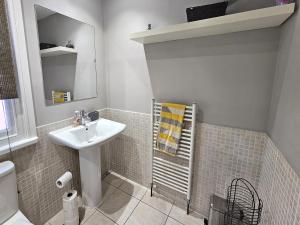 a bathroom with a sink and a mirror at Knighton Villa in Leicester