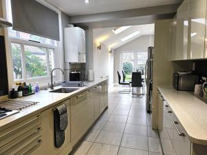 a kitchen with a sink and a counter top at Knighton Villa in Leicester