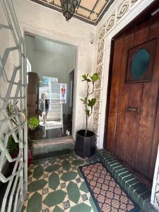 a hallway with a wooden door and a potted plant at Hotel Boutique & Spa Puerto Natura in Valparaíso