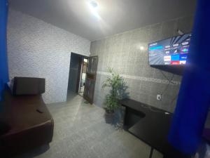 a room with a flat screen tv on a wall at Casa Geminada in Contagem