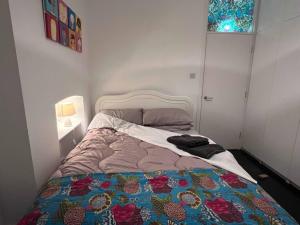 a bedroom with a bed with a quilt on it at Stylish Ground Floor 2 Bedroom Apartment In Pontcanna in Cardiff