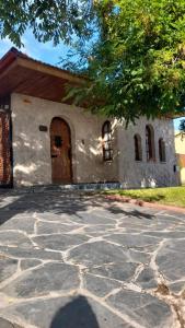 a building with a large door and a stone driveway at El Fortin in Mar del Plata