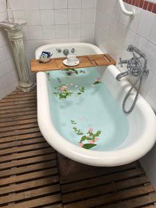 a bath tub with a painting of flowers on it at Hotel Boutique & Spa Puerto Natura in Valparaíso
