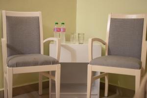 two chairs and two bottles of water on a table at Diosamar Hotel y Suites in El Valle