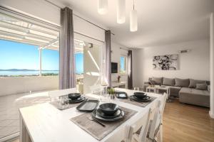 a kitchen and living room with a table and chairs at Villa Pearl in Tribunj
