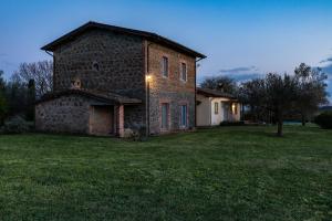 an old brick building in a field of grass at Casale del Rosmarino - Monolocale Melograno in Montefiascone